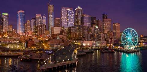 Seattle skyline at night, illuminated buildings, Seattle Aquarium, and the Great Wheel. Urban...