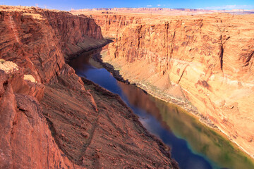 A river runs through a canyon with a rocky shoreline