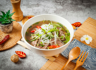 Beef Pho with herbs served in bowl isolated on grey background side view of taiwan food