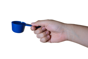 Hand holding a blue plastic measuring scoop isolated on transparent background. 