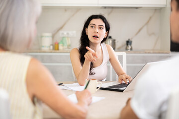 Realtor and apartment owners discuss terms of sale in home interior