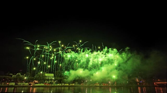 Beautiful Sparkling Colorful Fireworks in the night sky with reflections on the Main river Wide shot with Light Trails in the sky during Mainfest in Frankfurt Hessen Germany Deutschland
