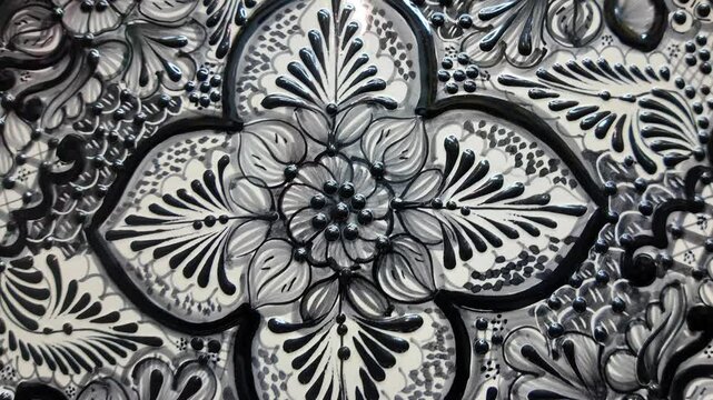 A black and white plate with a flower design
