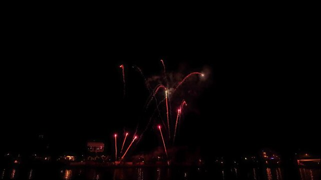 Beautiful Sparkling Colorful Fireworks in the night sky with reflections on the Main river Wide shot with Light Trails in the sky during Mainfest in Frankfurt Hessen Germany Deutschland
