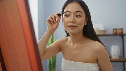 Woman applying makeup at spa or beauty salon, showcasing relaxation and wellness in an indoor...
