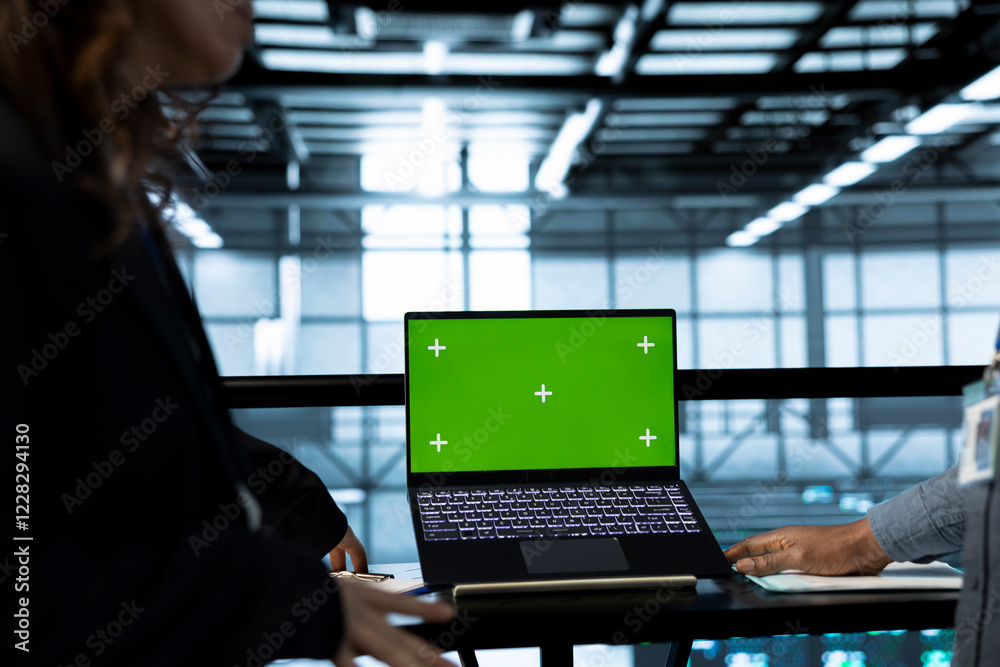 Poster computer scientists in data center using isolated screen mockup laptop to do network virtualization.