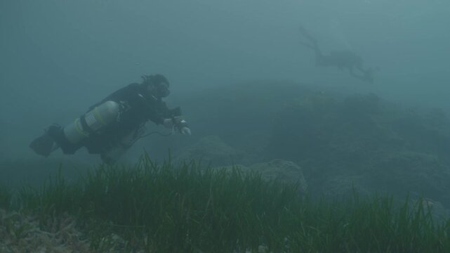 log footage of divers exploring underwater