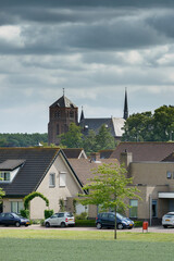 Exploring the serene landscape of Standdaarbuiten with traditional architecture and a visible church tower