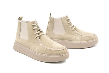 Fashionable suede leather boots on lacing isolated on white background. View from all sides.