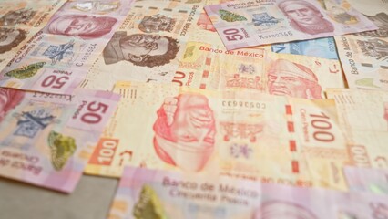 Mexican banknotes displayed on a flat surface showcasing various denominations and designs from banco de mÃ©xico.