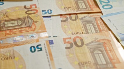 Closeup image showing 50 euro banknotes scattered over each other providing a detailed view of european union currency