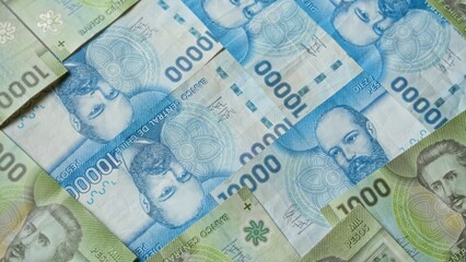 Chilean banknotes of various denominations are spread out, showcasing the colorful currency and intricate designs, representing the financial landscape of chile vividly.