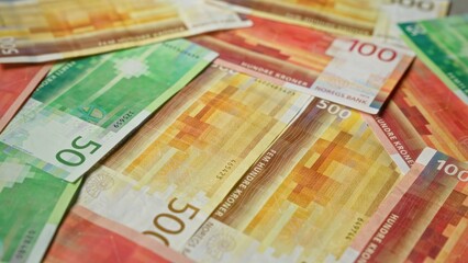 Colorful norwegian kroner, featuring primarily 50, 100, and 500 banknotes from norges bank, scattered across a surface highlighting the currency's vibrant design.