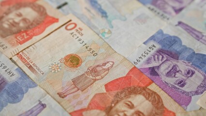 Colombian banknotes scattered with detailed portraits showcasing the currency of colombia in pesos.