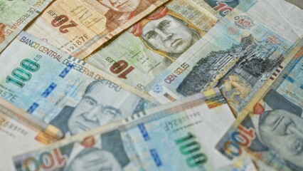 Peruvian banknotes of various denominations scattered showcasing intricate designs and vibrant colors representing the national currency, soles, from the banco central de reserva del perÃº.