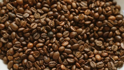 Roasted coffee beans closeup photography showing rich textured and vibrant coffee detail perfect for cafes and businesses related to coffee production and sales