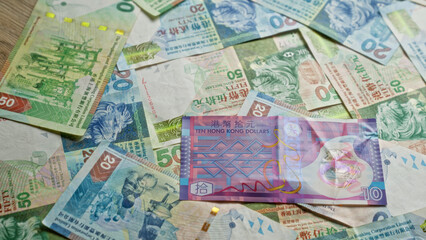 Hong kong dollars scattered in various denominations, showcasing colorful currency notes from hong kong in a close-up view