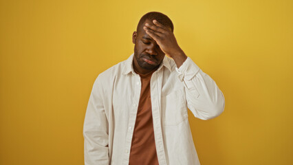 Fototapeta premium Handsome young african american man against isolated yellow background appearing pensive and concerned