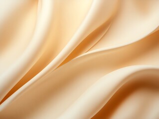 Obraz premium An elegant close-up of soft, flowing fabric in a warm beige tone. The smooth texture creates a sense of luxury and sophistication, perfect for fashion or interior design.