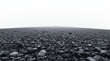 Black gravel plain disappearing into the misty Icelandic fog