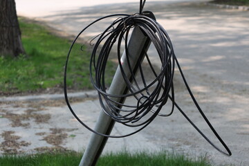 bundle of utility cable left hanging on a support wire for future installation