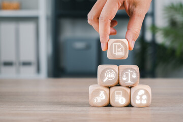 Wooden blocks with financial icons representing key accounting concepts like growth, strategy, and...