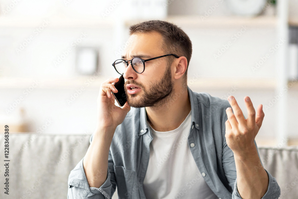 Poster stressed young freelancer using laptop and making call on smartphone at home office. millennial cauc
