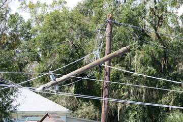 broken telephone pole after hurricane damage