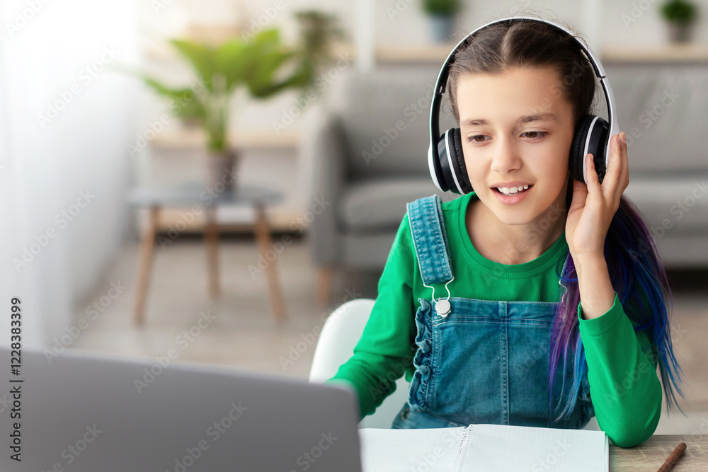 Poster good connection, e-learning concept. portrait of teenafe girl touching wireless headphones, sitting 