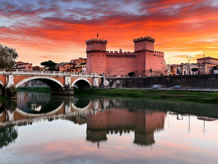 Fototapeta premium Historic Fortress Reflects in Calm River at Scenic Sunset with Dramatic Sky