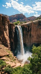 Majestic Waterfall Cascading Down Rocky Cliff in a Vibrant Landscape