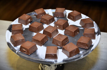 Plate with dark chocolate cubes for the cocktail