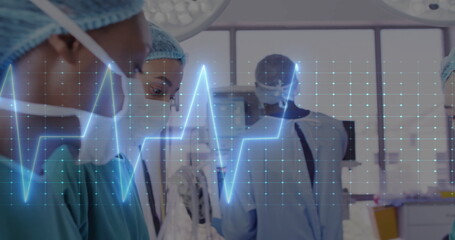 Image of cardiograph over diverse doctors during surgery