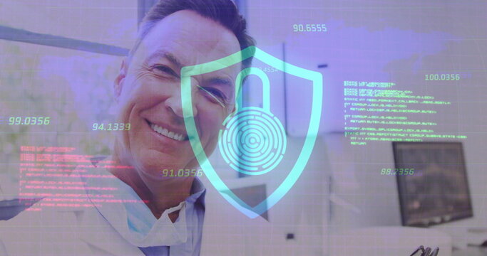 Image of data processing with padlock icon over caucasian male doctor using tablet in hospital