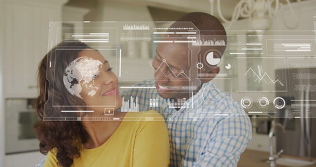 Image of financial data processing over biracial couple in kitchen
