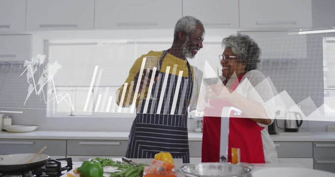 Image of financial data processing over biracial senior couple in kitchen - Powered by Adobe