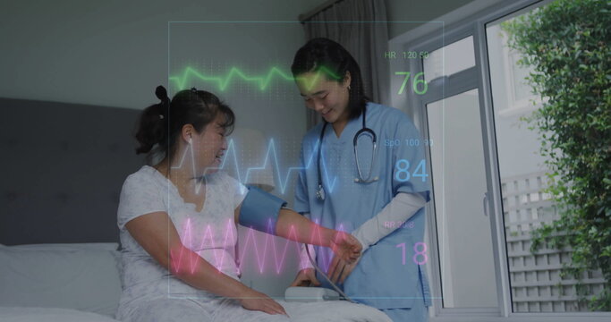 Image of cardiograph over senior asian woman with female nurse taking pressure