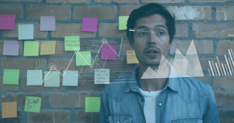 Image of financial data processing over biracial businessman in office