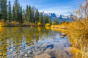 Clear water pond with mountains peaks in the background