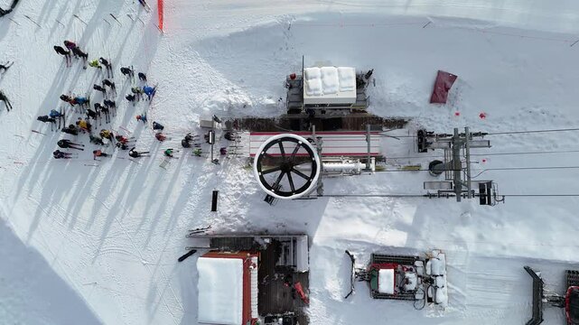 Birdseye of skiers lining up Three Kings chairlift spinning Park City, Utah