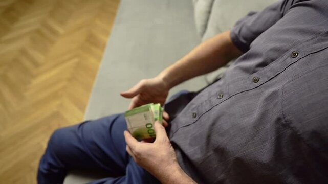 Counting EURO coins notes. EURO Money cash in hand. EURO bills and coins of European Union. Male hands counting Coins. 100 EURO Money Banknotes for pay. Hands counting money pack of hundred bills. 