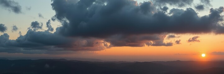 Dark gray clouds gather in the distance as the sun sets over a serene landscape of hills and valleys, sunset backdrop, scenic views, gradient colors