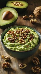Bowl of creamy guacamole topped with crunchy walnut pieces, surrounded by fresh avocado and walnut