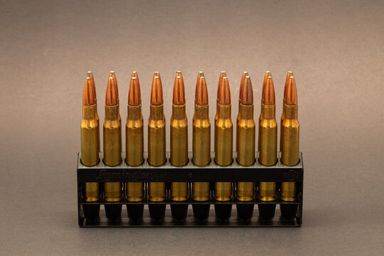 Rifle Ammo: 30-06 cartridges with soft point bullets in a black case on a dark background.