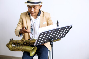 Saxophone Player Checking Mouthpiece Before Performing Music 