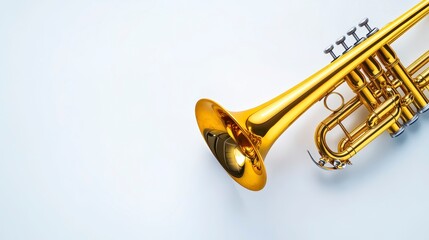 Obraz premium Shiny Gold Trumpet on Light Background Perfect for Music Themes
