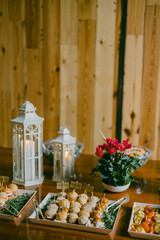 Elegant catering setup featuring appetizers and floral arrangements at a cozy event venue