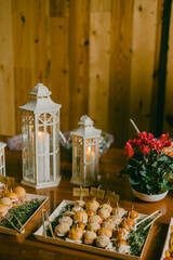 Elegant buffet display featuring sliders and lanterns at a cozy gathering