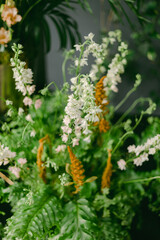 Colorful arrangement of fresh flowers in a vibrant indoor setting showcasing diverse plant life and greenery