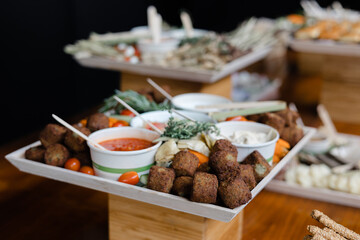 Delightful vegetarian platter featuring falafel, dips, and fresh vegetables at a catering event in the evening